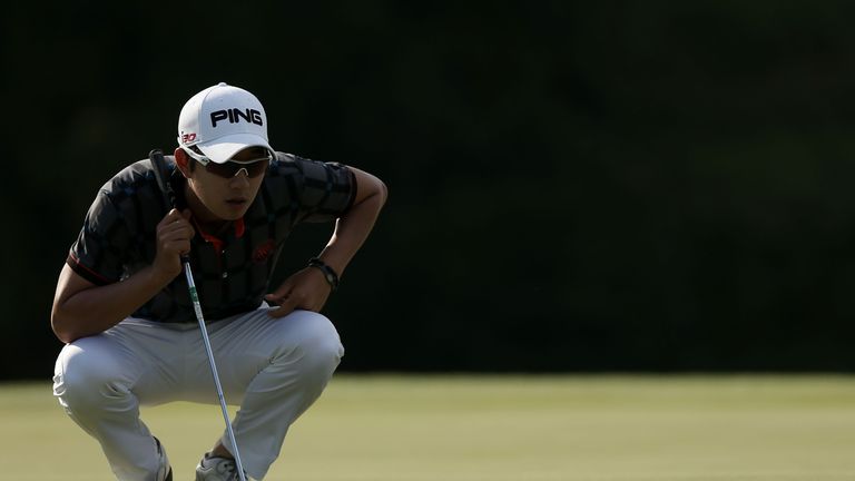 IBARAKI, JAPAN - SEPTEMBER 28:  Young-Han Song of Korea lines up his putt on the 18th green during day three of the Panasonic Japan Open at Ibaraki Golf Cl