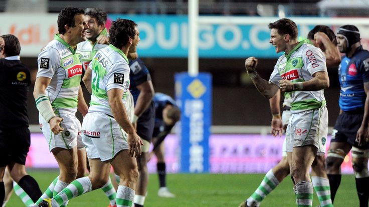 Pau's Colin Slade (R), Santiago Fernandez (C) and Damien Traille (L) celebrate at the end of the French Top 14 match between Montpellier and Pau