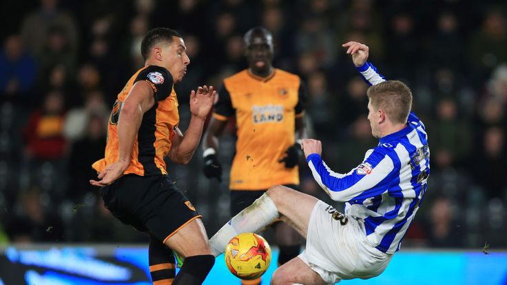 Hull City's Jake Livermore (left) and Sheffield Wednesday's Michael Turner battle for the ball