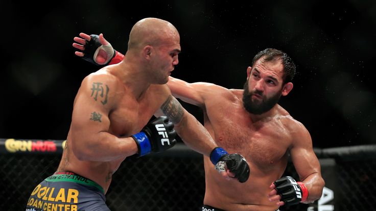 Robbie Lawler punches Johny Hendricks in their welterweight title fight during the UFC 181