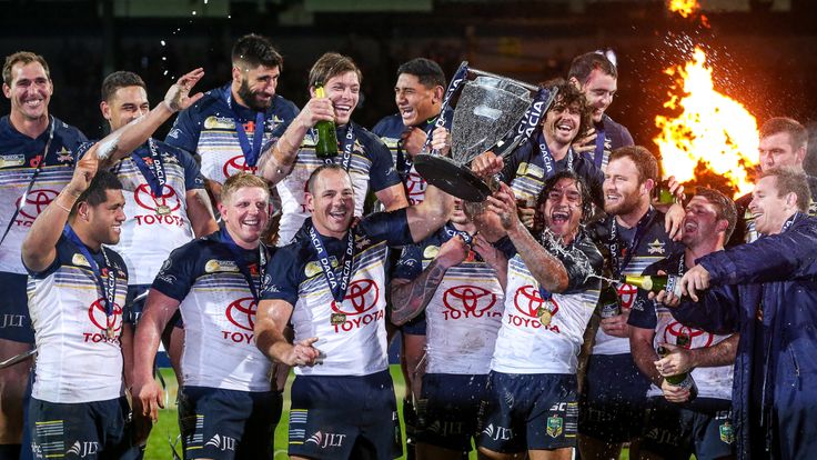 North Queensland Cowboys' co-captains Matt Scott, Johnathan Thurston and team-mates celebrate after their win over Leeds Rhinos