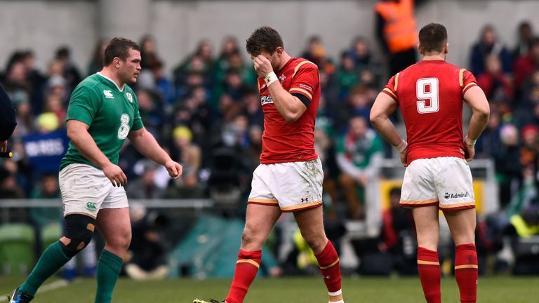 The injured Dan Biggar of Wales leaves the pitch midway through the first half 