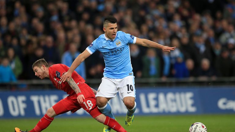 Manchester City's Sergio Aguero (right) goes down inside the penalty area after a challenge by Liverpool's Alberto Moreno