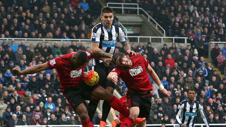 NEWCASTLE UPON TYNE, ENGLAND - FEBRUARY 06:  Aleksandar Mitrovic (C) of Newcastle United competes for the ball against Victor Anichebe (L) and Jonas Olsson