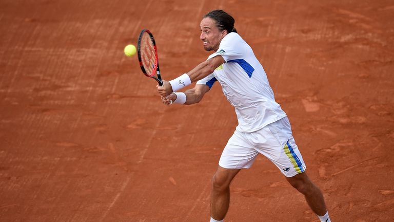 Alexandr Dolgopolov of Ukraine returns a shot to Thomaz Bellucci of Brazil during the Rio Open