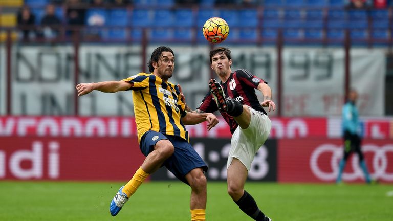 Alessio Romagnoli of AC Milan (R) and Luca Toni of Hellas Verona FC compete for the ball during the Serie A match betweeen AC Milan and Hellas Verona FC 