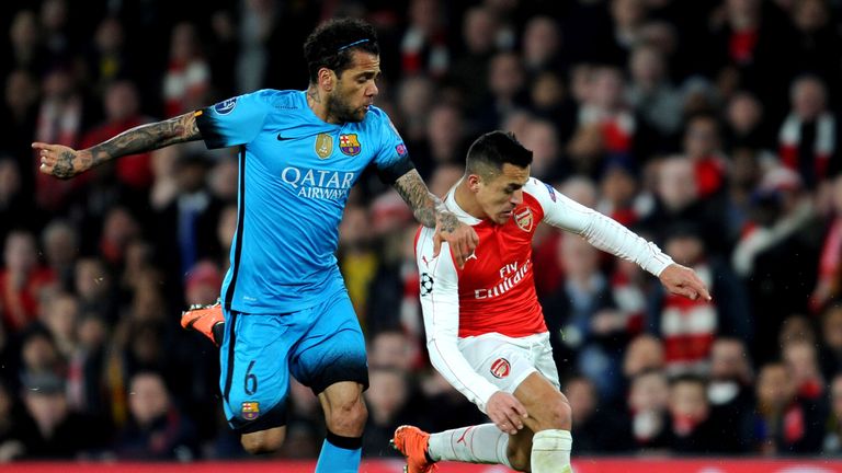 Arsenal's Alexis Sanchez is challenged by Barcelona's Dani Alves