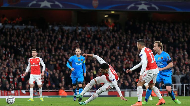 Arsenal's Alex Oxlade-Chamberlain (centre) gets a shot away at goal during the UEFA Champions League match at the Emirates Stadium, London.