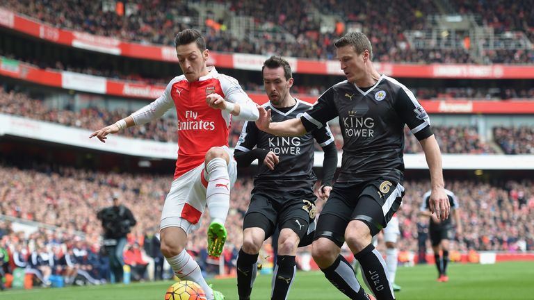 Mesut Ozil holds off Robert Huth