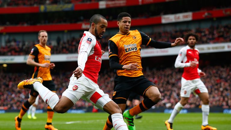 Theo Walcott of Arsenal and Curtis Davies of Hull City compete for the ball during the Emirates FA Cup fifth round match