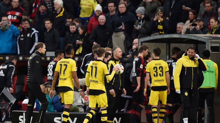 Players leave the pitch as referee Felix Zwayer suspends the match after Borussia Dortmund's first goal during the Bundesliga match with Bayer Leverkusen