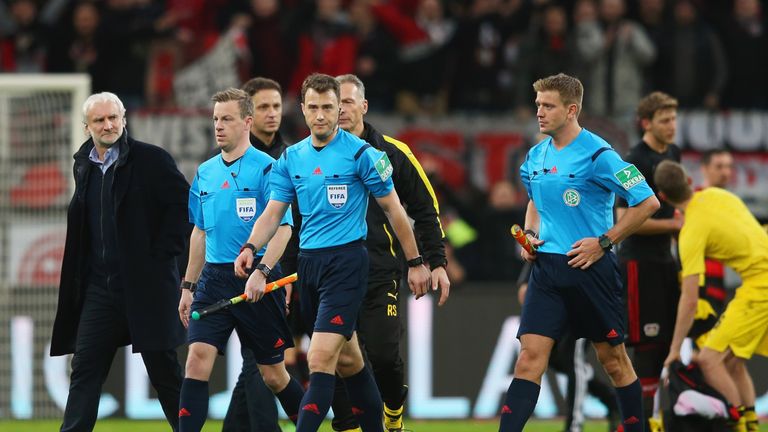 Referee Felix Zwayer and officials walk off the pitch after the Bundesliga match between Bayer Leverkusen and Borussia Dortmund