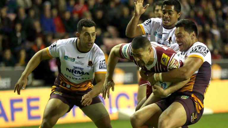 Wigan Warriors' Willie Isa (Centre) is stopped short of the try line by Brisbane Broncos' Alex Glenn (Right) during the World Club Series match
