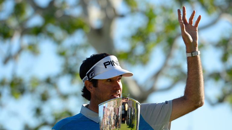 Bubba Watson poses with the trophy after putting in to win on the 18th hole during the final round of the Northern Trust Open