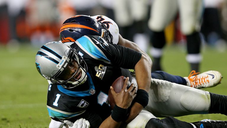 Cam Newton #1 of the Carolina Panthers is tackled by  DeMarcus Ware #94 of the Denver Broncos in the fourth quarter during 