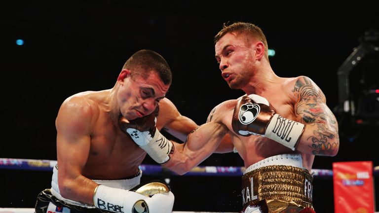 Carl Frampton (R) connects with a punch on Scott Quigg 