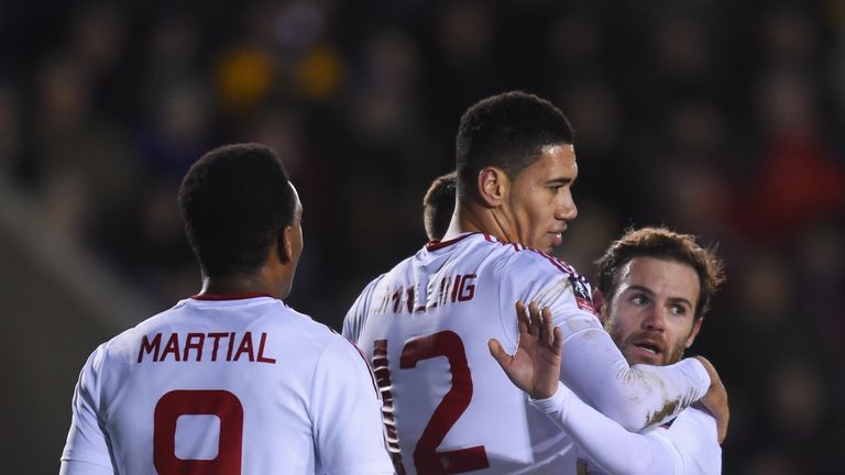 SHREWSBURY, ENGLAND - FEBRUARY 22:  Chris Smalling of Manchester United (12) celebrates with team mates Anthony Martial (9) and Juan Mata (8) as he scores 