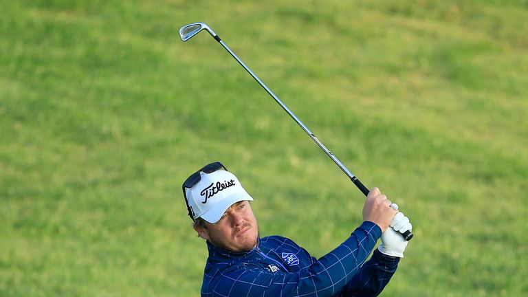 George Coetzee of South Africa plays his second shot at the par 5, 10th hole during the second round of the Omega Dubai Desert Classic