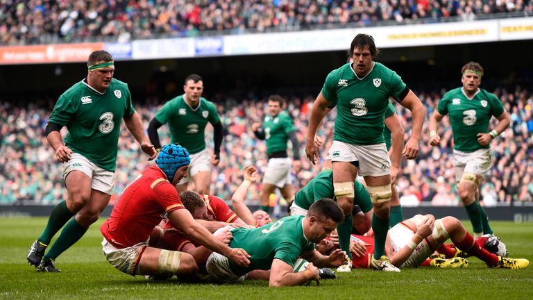Conor Murray of Ireland crashes through the tackle from Justin Tipuric of Wales to score the opening try