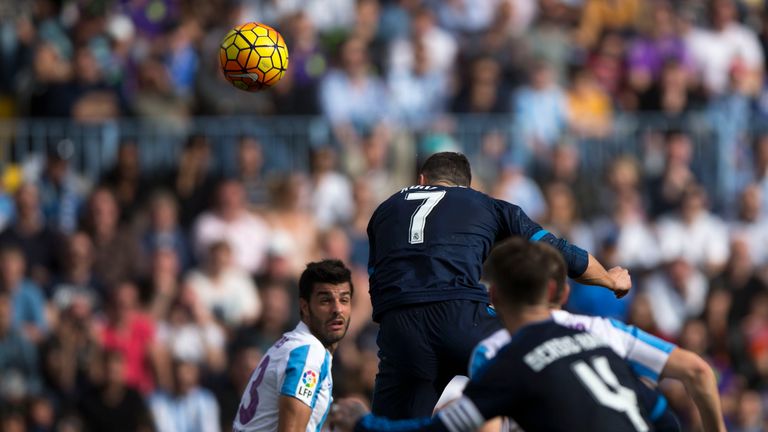 Cristiano Ronaldo heads Real Madrid's opening goal against Malaga