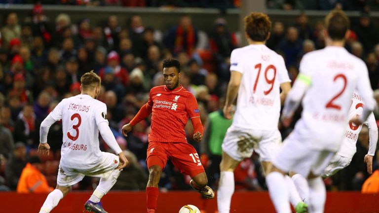 Daniel Sturridge of Liverpool and Kostas Stafylidis of Augsburg compete for the ball