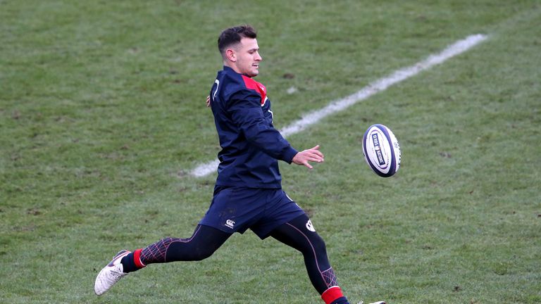 Danny Care kicks the ball upfield during an England training session 