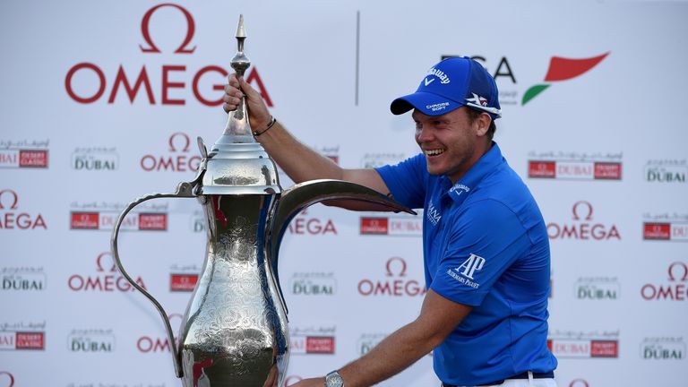 Danny Willett celebrates with the Dubai Desert Classic trophy
