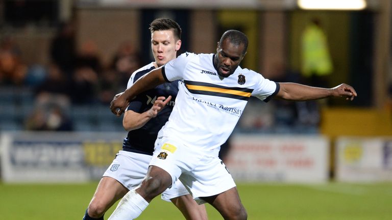 Dumbarton's Christian Nade (right) holds off Dundee's Thomas Konrad 