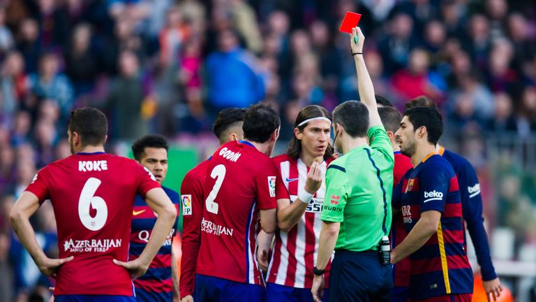 BARCELONA, SPAIN - JANUARY 30: Referee Alberto Undiano Mallenco shows a red card to Filipe Luis (3rd R) after fouling Lionel Messi during the La Liga match
