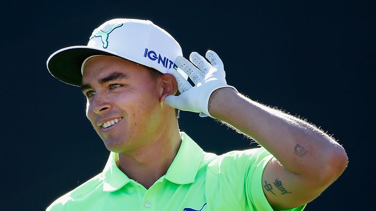 Rickie Fowler encourages the crowd to make even more noise as he tees off on the 16th hole during the third round at TPC Scottsdale