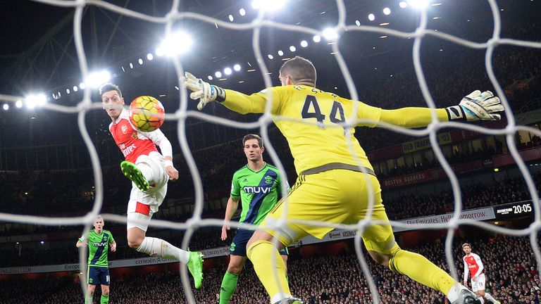 Fraser Forster denies Mesut Ozil in the first half with a point-blank save