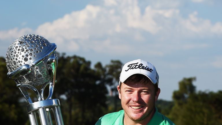 George Coetzee of South Africa holds the trophy for winning the Tshwane Open at Pretoria Country Club