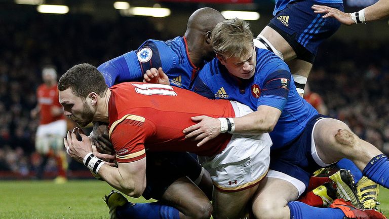 Wales' wing George North (L) scores his team's first try during the Six Nations international rugby union match 