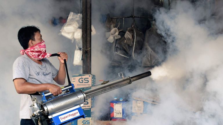 A man fumigates against mosquitos amid the Zika outbreak