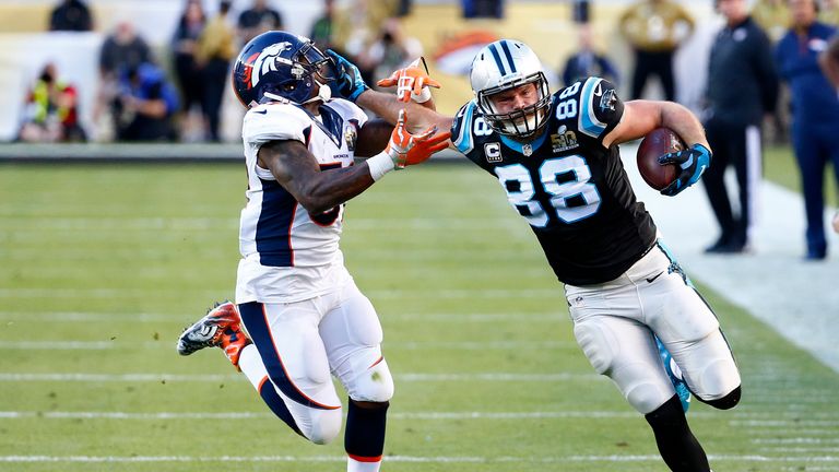Greg Olsen #88 of the Carolina Panthers runs after a catch against  Danny Trevathan #59 of the Denver Broncos