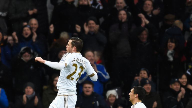 SWANSEA, WALES - FEBRUARY 06:  Gylfi Sigurdsson (L) of Swansea City celebrates scoring his team's first goal with his team mate Jack Cork (R) during the Ba