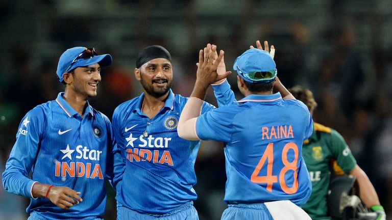 Indian bowler Harbhajan Singh (C) and fielder Suresh Raina(R) celebrate with their teammates after the dismissal of South African batsman David Miller