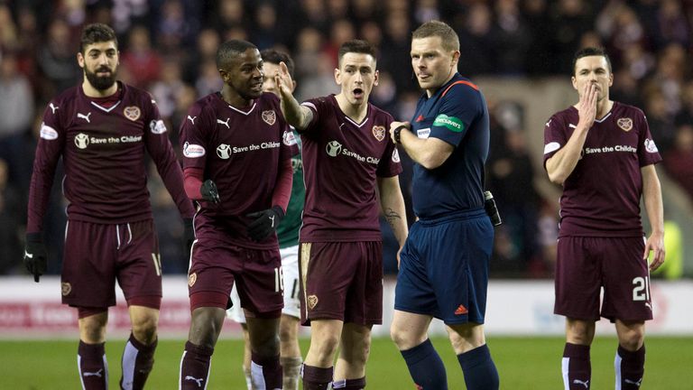 The Hearts player surround referee John Beaton 