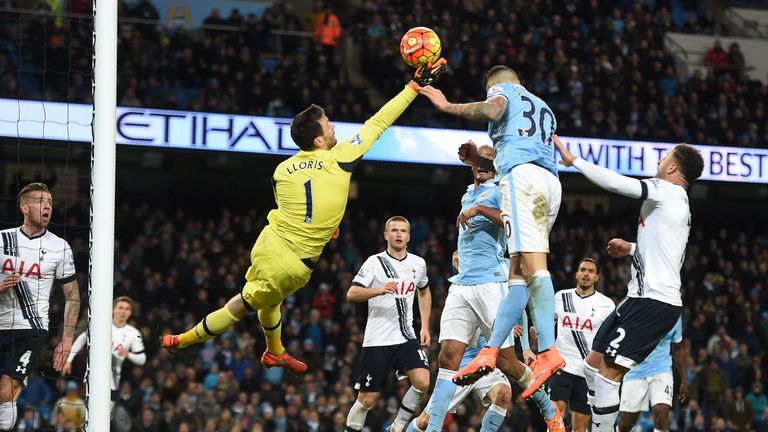 Tottenham Hotspur's French goalkeeper Hugo Lloris (L) saves the ball from Manchester City's Argentinian defender Nicolas Otame