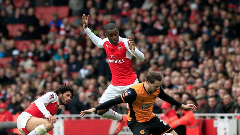 Hull City's Nick Powell (right) is brought down by Arsenal's Joel Campbell (centre) 