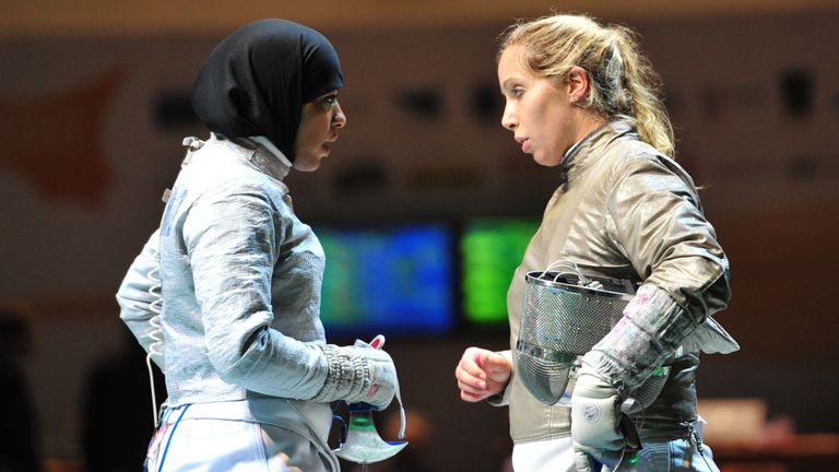 US Mariel Zagunis (R) and Ibtihaj Muhammad chat during their fight qith Team Italy at the Women's Team Sabre competition at the 2011 World Fencing Champion