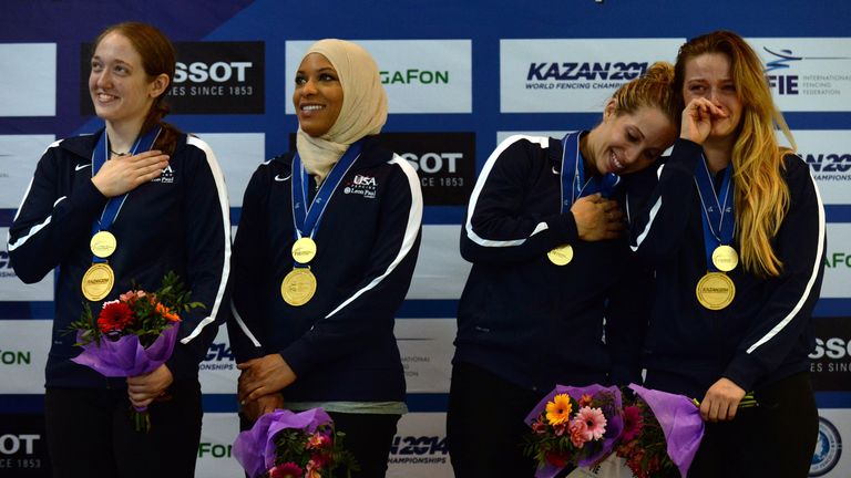 (From L) Anne-Elisabeth Stone, Ibtihaj Muhammad, Mariel Zagunis and Dagmara Wozniak of the United States react as they celebrate with their medals on the p