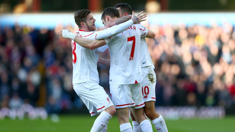 James Milner celebrates with team-mates after his cross found the bottom corner for the second goal