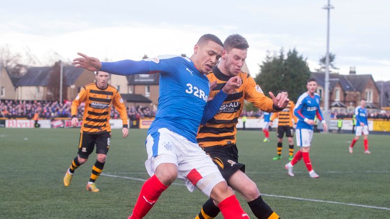 Rangers' James Tavernier (left) and Alloa's Mitch Megginson (right) battle for the ball 