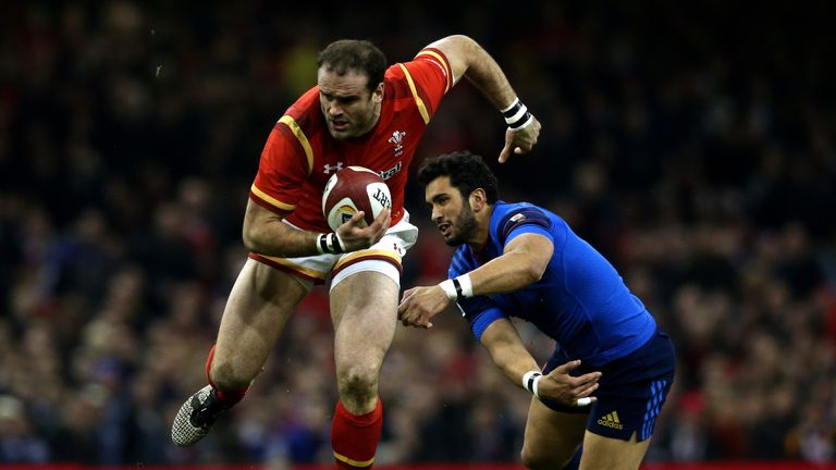 Jamie Roberts of Wales evades the tackle from Maxime Mermoz of France