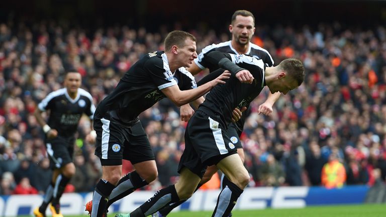 Jamie Vardy of Leicester City celebrates with team-mates after scoring the opening goal from the penalty spot against Arsenal