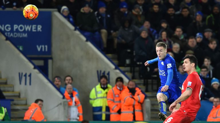 Leicester City's English striker Jamie Vardy (L) shoots to score the opening goal against Liverpool