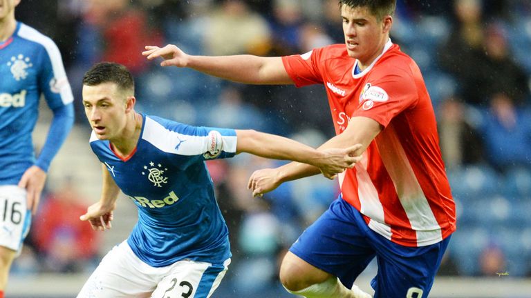 Jason Holt of Rangers holds off a challenge in a match against Cowdenbeath