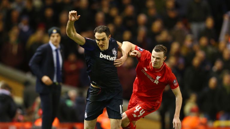Joey O'Brien of West Ham United holds off Joe Allen of Liverpool during the Emirates FA Cup Fourth Round match between Liverpool and West Ham at Anfield
