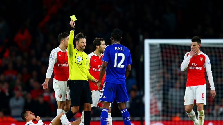 Chelsea's John Obi Mikel is shown a yellow card for a foul on Arsenal's Alexis Sanchez during the Premier League match at Emirates Stadium in January 2016 